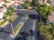 Gated community entrance, surrounded by mature palm trees and landscaping, ensuring residents privacy and security at 5049 Running Rapids Ave, Las Vegas, NV 89130