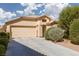 Inviting single-story home featuring a well-maintained front yard and a two-car garage at 5049 Running Rapids Ave, Las Vegas, NV 89130