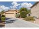 Inviting single-story home featuring a well-maintained front yard and a two-car garage at 5049 Running Rapids Ave, Las Vegas, NV 89130
