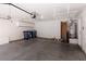 An attached garage with painted concrete floors and built-in storage cabinets at 5049 Running Rapids Ave, Las Vegas, NV 89130