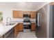 A contemporary kitchen featuring stainless steel appliances and light wood cabinetry at 5049 Running Rapids Ave, Las Vegas, NV 89130