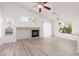 Bright living room featuring a fireplace, ceiling fan and sliding glass door at 5049 Running Rapids Ave, Las Vegas, NV 89130