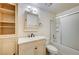 Bright bathroom with white vanity, shower/tub combo, and built-in shelves at 5121 Gains Mill St, Las Vegas, NV 89122
