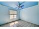 View of a bedroom with tile flooring, ceiling fan, and natural light at 5121 Gains Mill St, Las Vegas, NV 89122