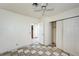 Bedroom featuring tile floors, ceiling fan, closet and access to another room at 5121 Gains Mill St, Las Vegas, NV 89122