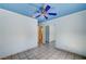 View of a bedroom with blue ceiling, ceiling fan, tile floors and closet at 5121 Gains Mill St, Las Vegas, NV 89122