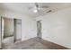 Bedroom featuring carpet, ceiling fan, closet and access to another room at 5121 Gains Mill St, Las Vegas, NV 89122