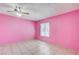 Bedroom featuring tile flooring, a window with blinds, and bright pink walls at 5121 Gains Mill St, Las Vegas, NV 89122