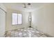 View of a bedroom featuring checkered flooring, a ceiling fan, and a window at 5121 Gains Mill St, Las Vegas, NV 89122