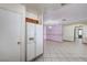 Spacious kitchen featuring tile floors and access to the living room and back door at 5121 Gains Mill St, Las Vegas, NV 89122