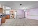 Kitchen featuring oak cabinets, tile floor and black appliances with a dining area view at 5121 Gains Mill St, Las Vegas, NV 89122