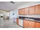 Functional kitchen with wooden cabinetry, granite countertops, a double sink, and tile flooring at 5121 Gains Mill St, Las Vegas, NV 89122