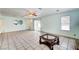 Bright living room with a ceiling fan, tile flooring and natural light, creating a cozy space at 5121 Gains Mill St, Las Vegas, NV 89122