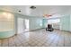 Comfortable living room with an arched wall, ceiling fan and tile flooring, offering a relaxing atmosphere at 5121 Gains Mill St, Las Vegas, NV 89122