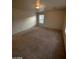 Bedroom featuring neutral carpet, a window, and a doorway at 5413 Bristol Bend Ct, Las Vegas, NV 89135