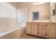 Bright bathroom with a tub, tile surround, and a vanity with double sinks at 5415 W Harmon Ave # 1162, Las Vegas, NV 89103