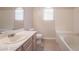 Well-lit bathroom featuring a vanity, toilet, and a bathtub with tiled walls at 5415 W Harmon Ave # 1162, Las Vegas, NV 89103