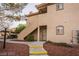 Exterior of a condo unit with private entrance, small yard, and covered parking at 5415 W Harmon Ave # 1162, Las Vegas, NV 89103