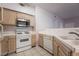 Kitchen with a stainless steel microwave, tile floors, and light-toned cabinets at 5415 W Harmon Ave # 1162, Las Vegas, NV 89103