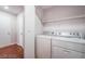 A functional laundry area with a washer, dryer, and shelving for storage at 5415 W Harmon Ave # 1162, Las Vegas, NV 89103