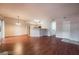 Open-concept floor plan with wood flooring, bright kitchen, and light-filled living space at 5415 W Harmon Ave # 1162, Las Vegas, NV 89103
