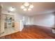 Open-concept living room featuring wood floors and adjacent kitchen with white appliances at 5415 W Harmon Ave # 1162, Las Vegas, NV 89103