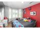 Bedroom with a large bay window, playful decor, and wood laminate flooring at 5424 Geneive Ln # 105, Las Vegas, NV 89108