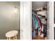 Bedroom walk-in closet including hanging clothes, boxes, and shelving with wood laminate flooring at 5424 Geneive Ln # 105, Las Vegas, NV 89108