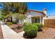 Charming single-story home with a terracotta roof, landscaped yard, and decorative gate at 5424 Geneive Ln # 105, Las Vegas, NV 89108