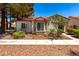 Charming single-story home with a terracotta roof, bay windows, and xeriscaped landscaping at 5424 Geneive Ln # 105, Las Vegas, NV 89108