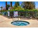 Inviting in-ground hot tub with tile detail and relaxing sun lounger surrounded by lush greenery at 5424 Geneive Ln # 105, Las Vegas, NV 89108