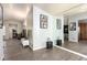 Spacious living room with wood-look flooring, neutral walls, large mirror, and a comfortable, open layout at 5424 Geneive Ln # 105, Las Vegas, NV 89108