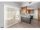 Bright room featuring hardwood floors, wet bar area and slider door, offering a versatile living space at 5424 Geneive Ln # 105, Las Vegas, NV 89108