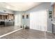 Bright room featuring hardwood floors, a large mirror and slider door, offering a versatile living space at 5424 Geneive Ln # 105, Las Vegas, NV 89108