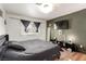 Inviting bedroom featuring hardwood floors, a television, and large window offering a comfortable retreat at 5424 Geneive Ln # 105, Las Vegas, NV 89108