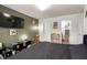 Relaxing bedroom featuring hardwood floors, a television, and multiple doors offering a comfortable retreat at 5424 Geneive Ln # 105, Las Vegas, NV 89108