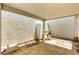 Covered outdoor patio area with textured walls and concrete flooring at 5424 Geneive Ln # 105, Las Vegas, NV 89108