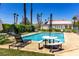 Sparkling community pool with lounge chairs and picnic table, perfect for relaxing and entertaining at 5424 Geneive Ln # 105, Las Vegas, NV 89108