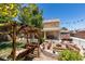 Well-designed backyard with a swing, fire pit area, outdoor kitchen, and plenty of space for entertaining at 6109 Sandstone Mesa Dr, Las Vegas, NV 89130