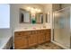 Bathroom features dual sinks, decorative mirrors, tub and walk-in shower at 6109 Sandstone Mesa Dr, Las Vegas, NV 89130