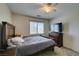 Bedroom with a large bed, window, ceiling fan and a dresser with a flat screen TV at 6109 Sandstone Mesa Dr, Las Vegas, NV 89130