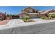 Charming home with landscaped front yard, desert landscaping, attached garage and additional gated parking on the side of the house at 6109 Sandstone Mesa Dr, Las Vegas, NV 89130