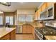 Granite countertops with a gas cooktop and stainless steel appliances at 6109 Sandstone Mesa Dr, Las Vegas, NV 89130