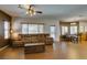 Bright living room with wood-look floors, comfortable seating, and natural light creating a cozy atmosphere at 6109 Sandstone Mesa Dr, Las Vegas, NV 89130