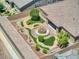 Aerial view of a meticulously landscaped backyard, featuring artificial turf and a central fountain at 6315 Carol Butte Ct, Las Vegas, NV 89141