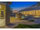 Backyard at twilight, showcasing a stone fountain, beautiful pavers, and ambient landscape lighting at 6315 Carol Butte Ct, Las Vegas, NV 89141