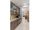 Wet bar with granite counter, sink, and glass cabinets at 6315 Carol Butte Ct, Las Vegas, NV 89141