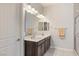 Bright bathroom with double sinks, modern fixtures, and a glass-enclosed shower at 6315 Carol Butte Ct, Las Vegas, NV 89141