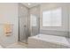 Luxurious soaking tub with tiled shower and neutral color scheme at 6315 Carol Butte Ct, Las Vegas, NV 89141
