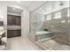 Bathroom with a spacious walk-in shower, soaking tub, and granite countertop at 6315 Carol Butte Ct, Las Vegas, NV 89141